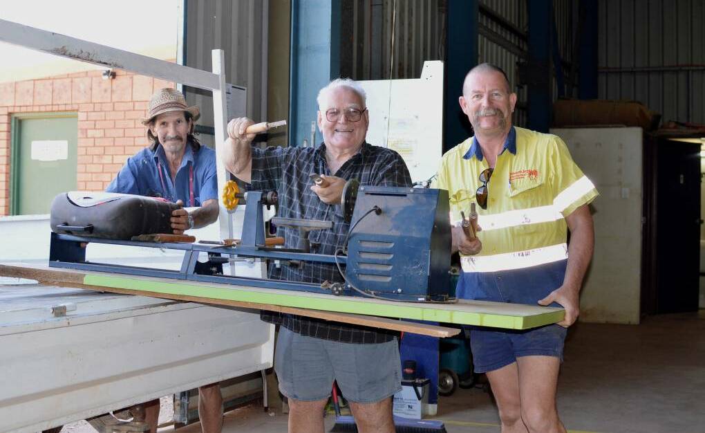 In 2015, Bob Mackie and Norm Baker help Shockless Electrical Services director Alistair Campbell load up the ute with unwanted tools donated by the business, which will be used in the Rotary Community Workshop.