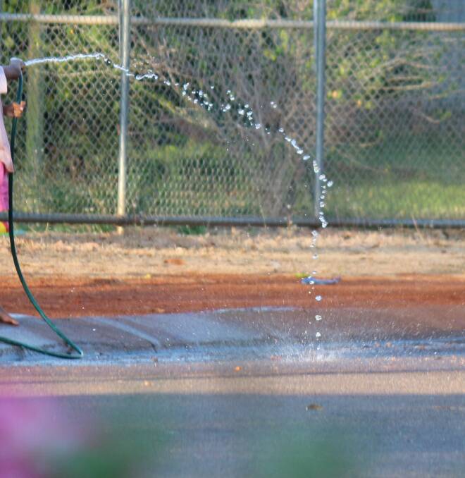 The Katherine resident's photograph she says shows people wasting water on a town street.
