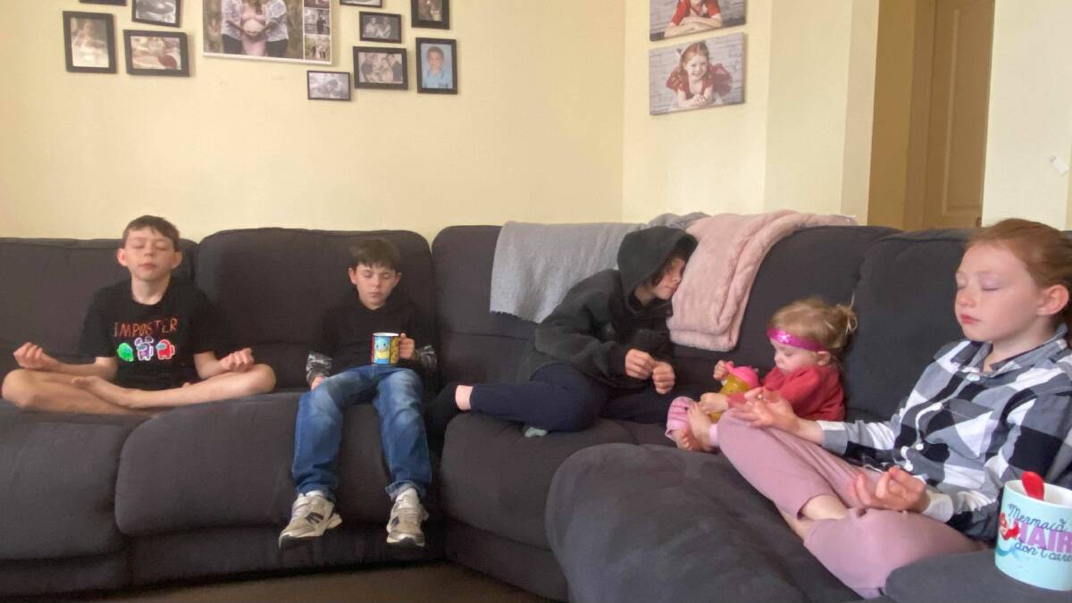 Smiling minds: Cassie Lake's five children taking a few minutes out of homeschooling to meditate is making life much easier for all concerned. Photo supplied