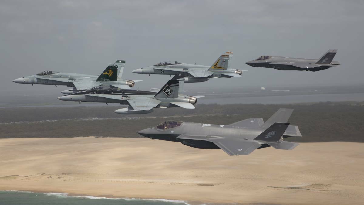 TRAINING: RAAF F/A-18 Hornets flying in formation with a pair of F-35A Joint Strike Fighters in 2018. Photo: Defence Media