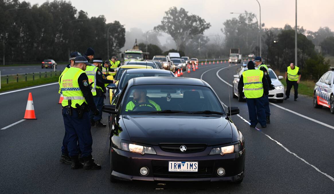 PERMIT CHECK: NSW Police were looking at permits in all cars crossing the border from Victoria into NSW on Wednesday. Picture: MARK JESSER