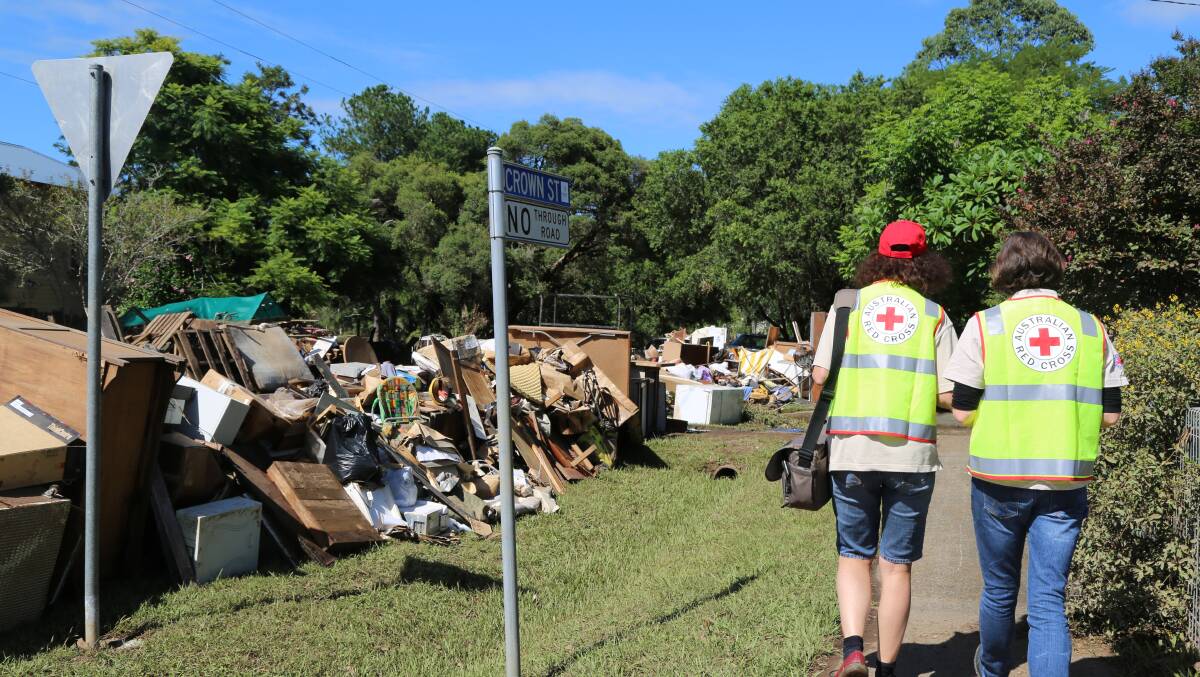 DEVASTATING: Emergency workers survey the aftermath of the Lismore flood in March. Emergency plans save lives. Photo AMELIA WONG, AUSTRALIAN RED CROSS