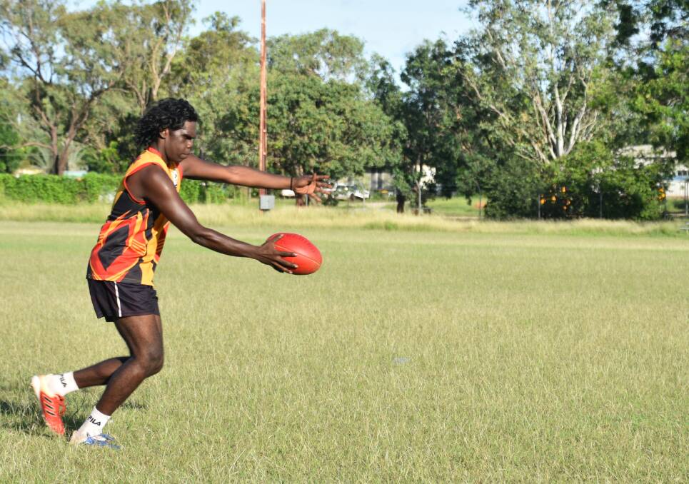 A Bombers player launches the ball at Thursday night training. Picture: Tom Robinson. 