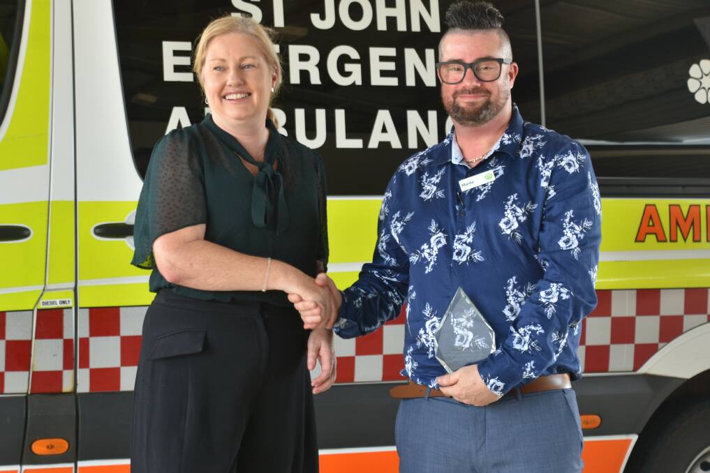 Monte receives his award from St John NT chief exectuve officer Judith Barker. Picture: Tom Robinson. 