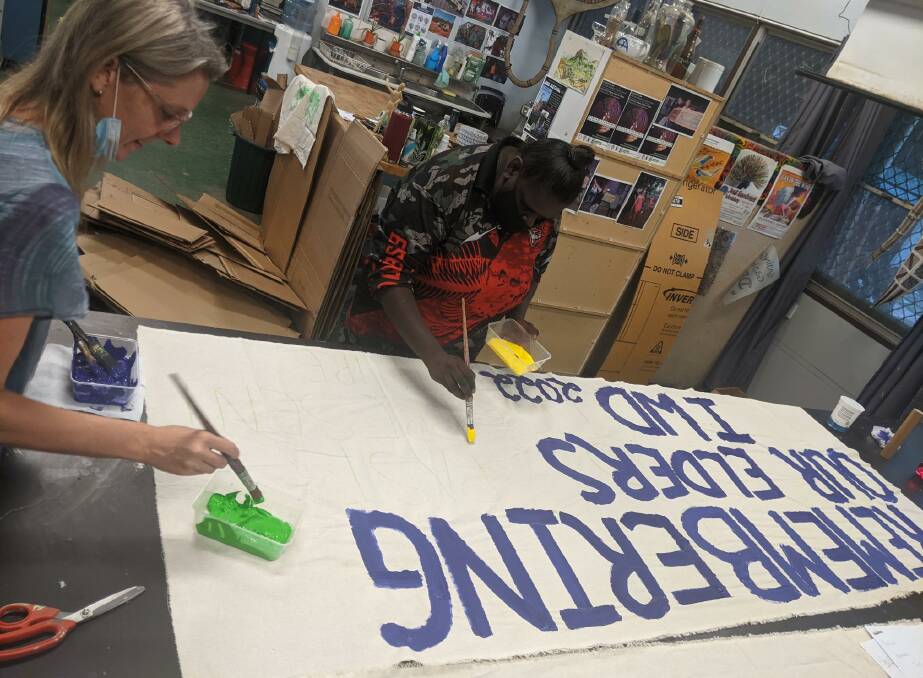 Katherine residents create International Women's Day banners at Katherine Regional Arts free workshops. Photo supplied.