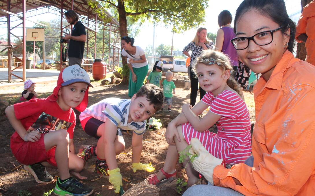 GREEN THUMB: Ryan Parkinson, Lucas Cowie, Sebella Cowie and Angie Siputro helping get invovled in the community garden at the morning tea.