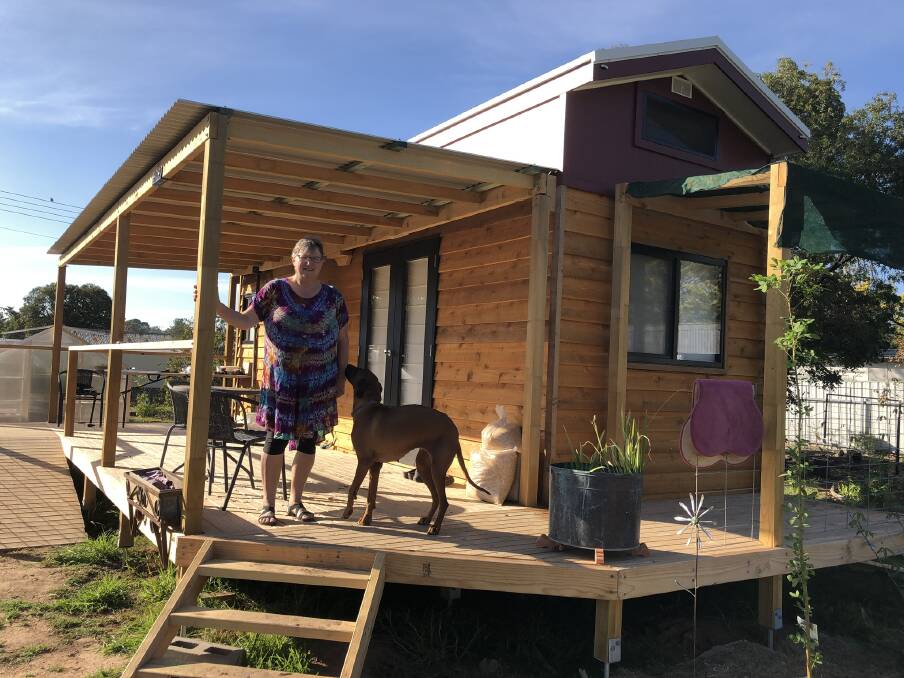 TINY HOUSE TREND: Boorowa resident Kathy McLennan, with her dog Honey, lives in a tiny house and says she doesn't miss her four-bedroom home lifestyle. Picture: supplied