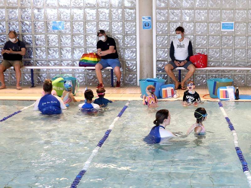Children's swimming lessons have resumed after NSW passed 70 per cent full vaccination coverage.