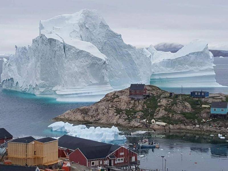 A massive iceberg is threatening to drown the village of Innaarsuit in northwestern Greenland.
