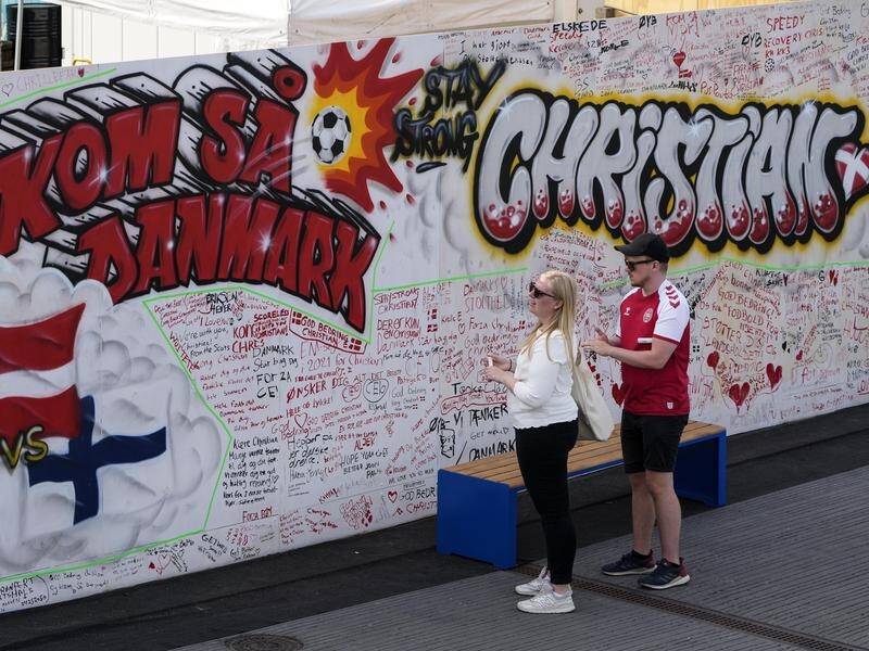 Fans leave well wishes for Danish player Christian Eriksen on a wall at the fanzone in Copenhagen.