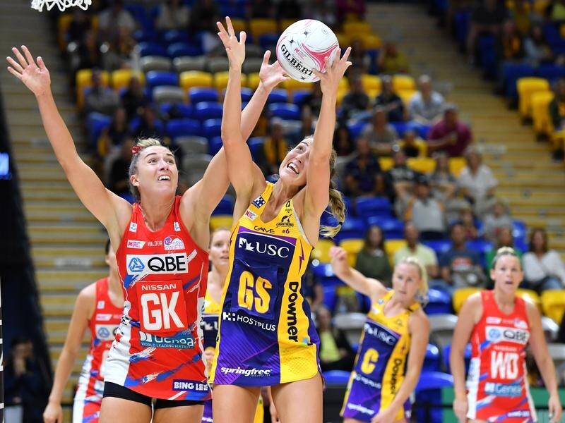 Sunshine Coast Lightning's Cara Koenen grabs possession under pressure from NSW Swifts' Sarah Klau.