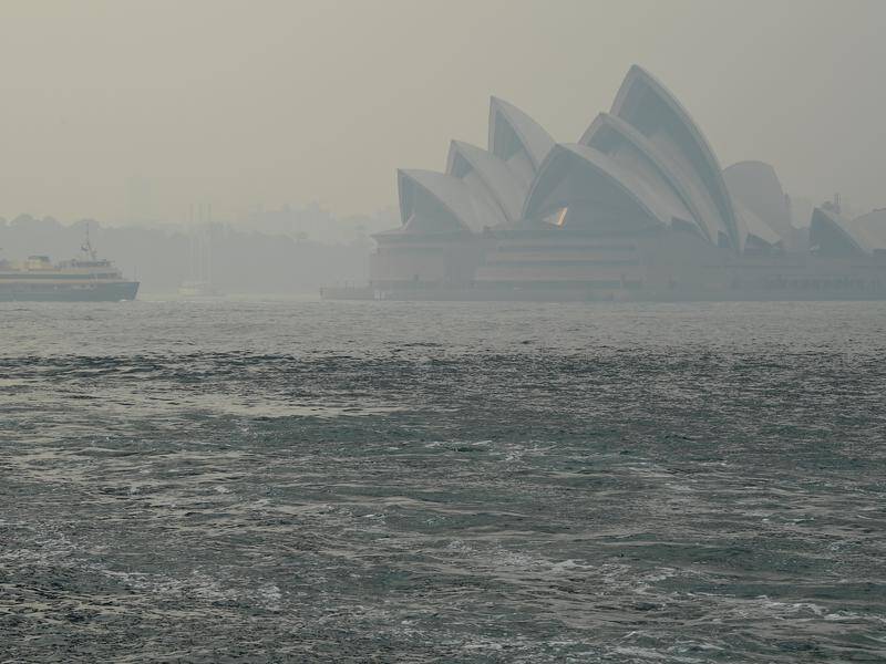 A smoke haze from bushfires in NSW blankets Sydney Harbour.