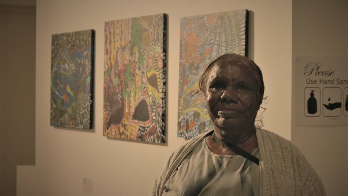 Janet Dreamer with her three works, all of which sold on the night.