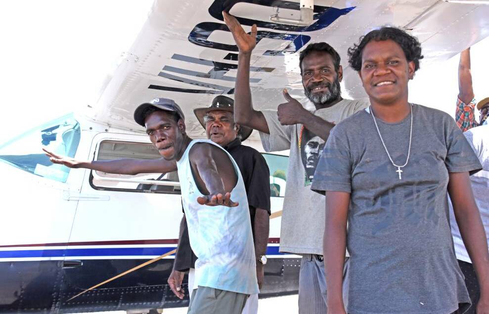 Community members of Gupawiyak in East Arnhem Land about to board the Cessna 211 taking them home.