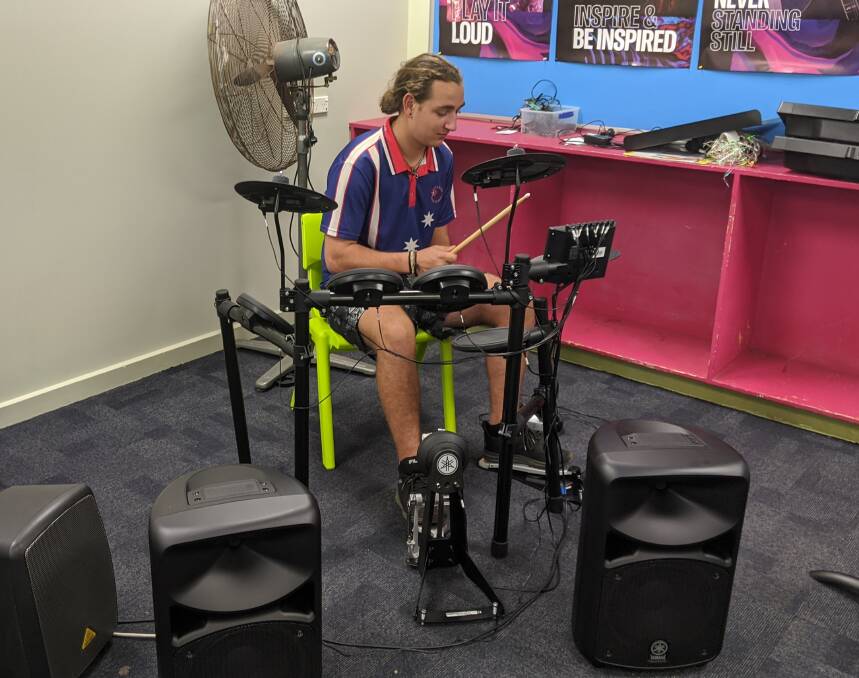 Katherine High School Year 11 student Ashton Wilson getting into it on the new drum kit.