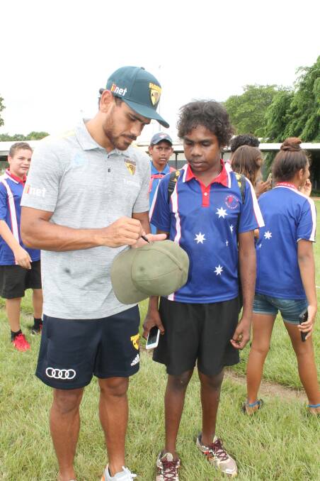 STAR ATTRACTION: High school student Tobias Hume was beaming after he got his cap signed by Rioli. 