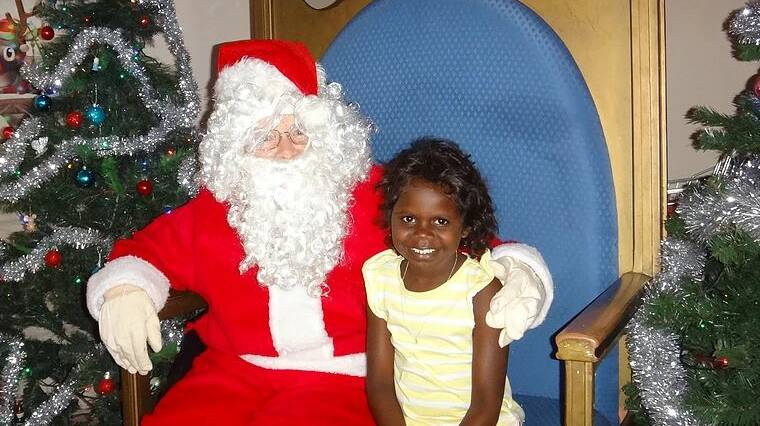 HAPPY TIME: Rotary volunteers provided free Santa photos to the Katherine community. 