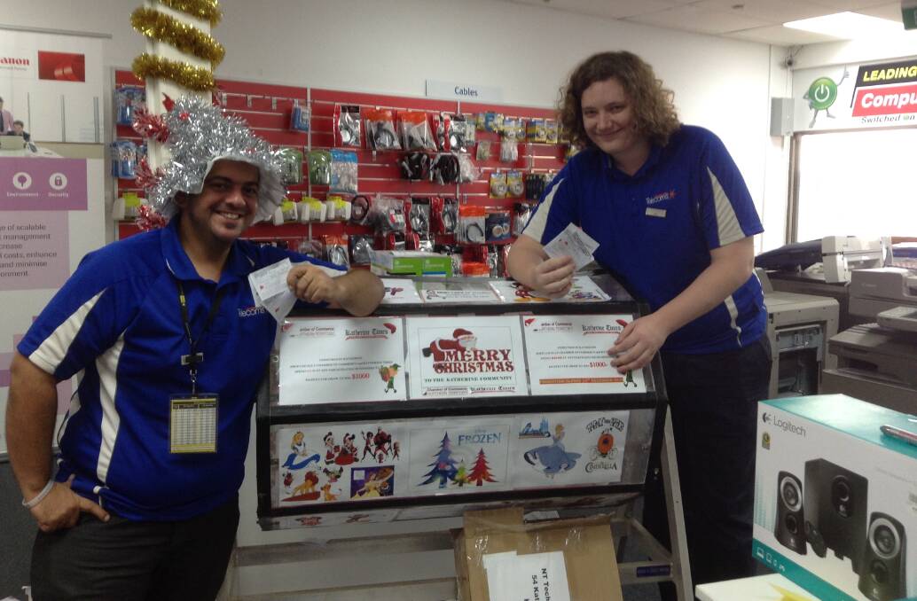 LUCKY DRAW: NT Technology staff hold the winning tickets. Picture: supplied.