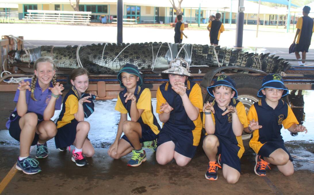 BIG CROC: Ebony Grosser, Isabelle Mead, Zach Healey, Jett Favio, Ben McPhee and Tom McPhee got up close and personal with the crocodile pulled from Katherine gorge this morning.