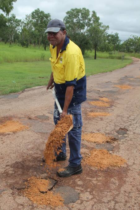 FIX UP: Workers from Kalano Community were conducting "emergency works" on the holes this morning. 